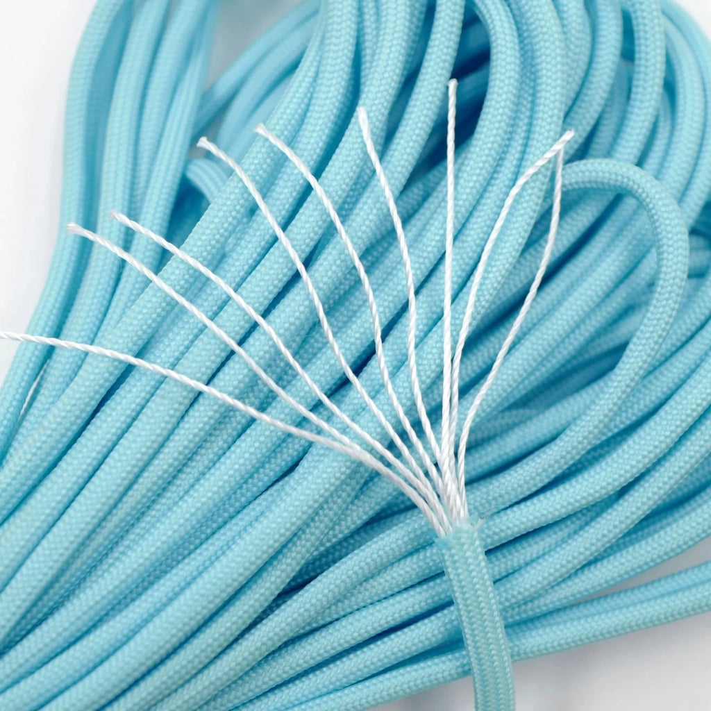 Close-up of blue braided cable with white core on a light gray background